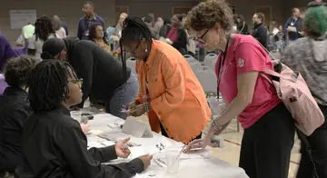 A reentry participant speaks with a volunteer