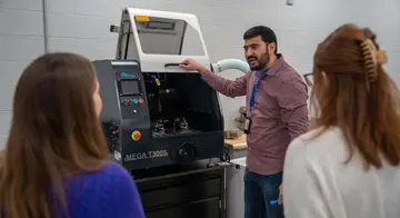 Dr. Anass Nassef shows new lab equipment to TCC faculty and staff