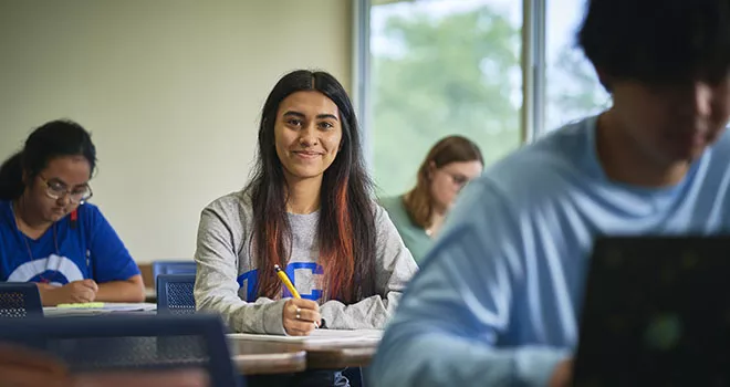 woman looking up from desk and smiling