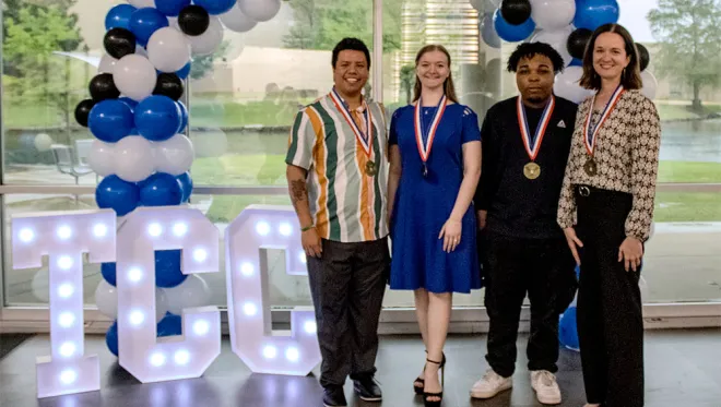 Four PVSA recipients pose for a photo