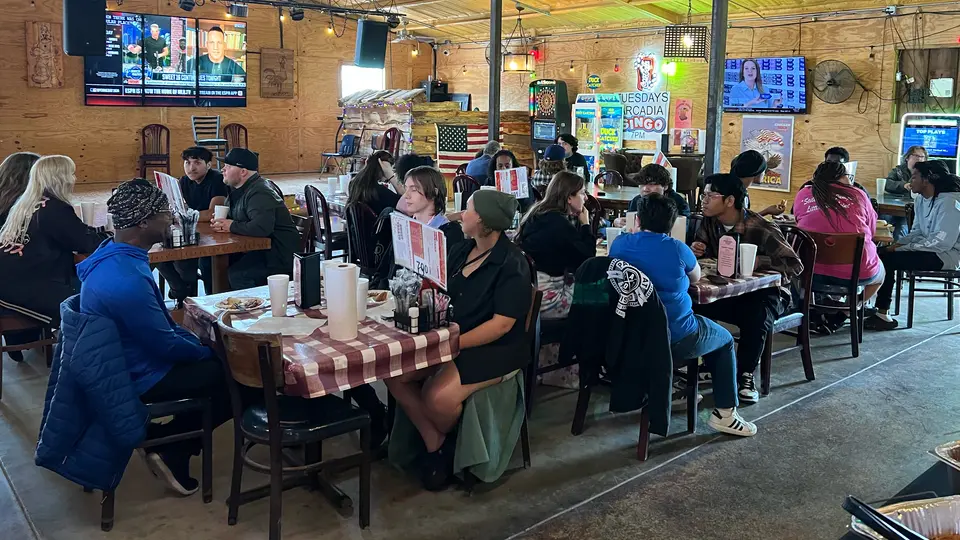 A large of group people sit at various tables at the Chicken Shack in Arcadia