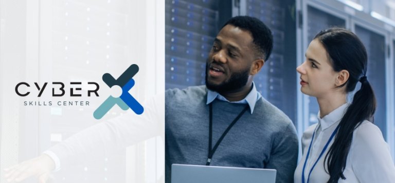 Cyber Skills Center. Black man holds computer in a server room while talking to a young white woman.