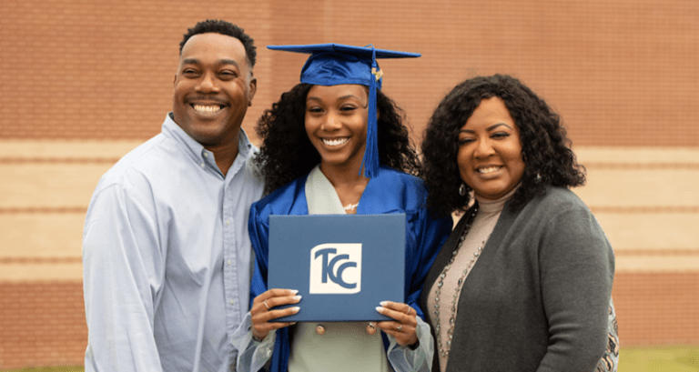 TCC Graduate in cap and gown with family